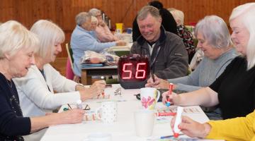 Cllr Mike Jordan calls the numbers for eager bingo players at Drax Wednesday Club using the new machine.