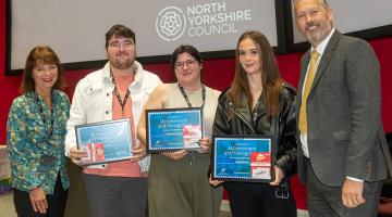 Young people holding their awards