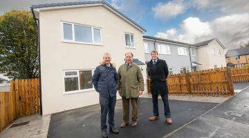 North Yorkshire councillor Simon Myers (centre) outside the new Harrogate homes.