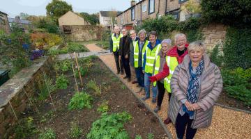 Member for the Skipton West and West Craven division, Cllr Andy Solloway, joins representatives from Carleton in Bloom in the community garden which is making a real difference to the local area. (From left to right) John Waterhouse, Cllr Solloway, Chris Judge, Sue Brown, Corinne Ludford, Fiona Steel, Carol Stocks and Vicki Woodhead.