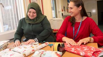 Ivana Gardner with learner Fatima spreading festive cheer for local asylum seekers.