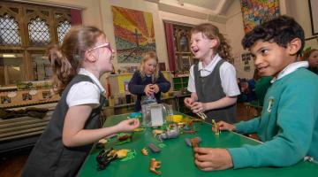 Four children at a childcare setting laughing 