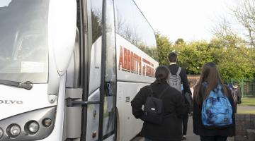 Children getting on a bus