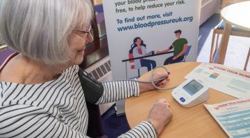 A lady getting her blood pressure checked