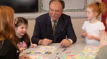 Cllr Kevin Foster lends a hand to designs for the hoardings.