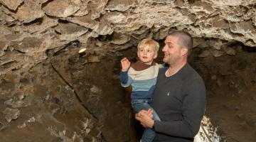 Visitors to Knaresborough Castle explore the underground tunnels.