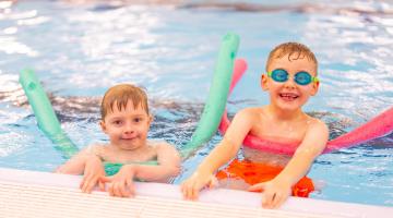 Two young boys using floats in the swimming pool at the Ripon Leisure and Wellbeing Hub - The Jack Laugher Centre
