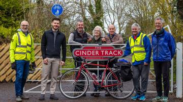 Cllr Keane Duncan (second left), with residents and volunteers from Sustrans on the upgraded Cinder Track. Credit: Phoebe Donbavand/Sustrans.