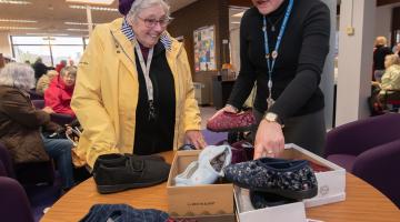 Dorothy and Philippa looking at slippers in a library