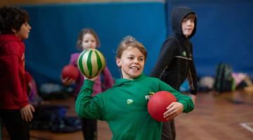 A young girl throwing a ball