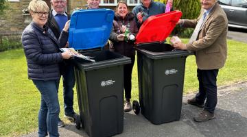 Cllr Greg White and residents putting items in the bin
