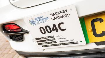 The back of a taxi showing the taxi licence 