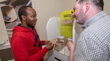 Two men at the seed display in Scarborough Library