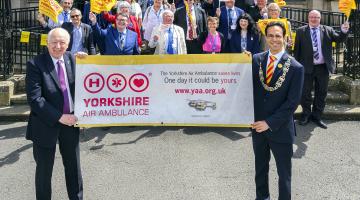 Elected members with a Great North Air Ambulance banner