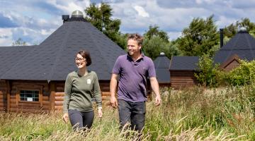Joanne and Sean Nicholson outside glamping pods that have been introduced at her family’s farm
