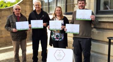 A group of four holding certificates at the Yorkshire in Bloom awards
