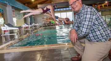 Cllr Gareth Dadd pictured with Thirsk White Horse swimmers ready to go to great lengths thanks to the arrival of their new diving blocks.