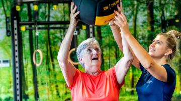 Two ladies with a ball in a gym