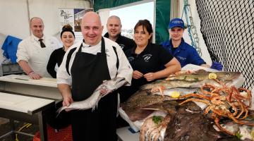 A group of chefs with a fish at Whitby Fish and Ships festival