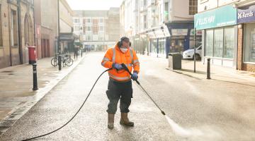A person cleaning chewing gum