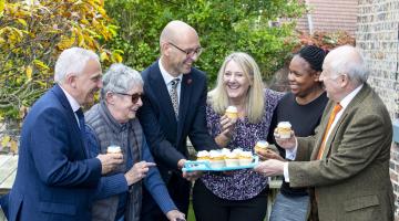 Cllr Michael Harrison, Maggie Donnelley, Richard Webb, Sam Spence, Fisani Mahlangu and Cllr Carl Les with cakes celebrating the rating of 81 for social care services for adults.