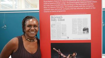 Marsha Lowe standing next to a display board