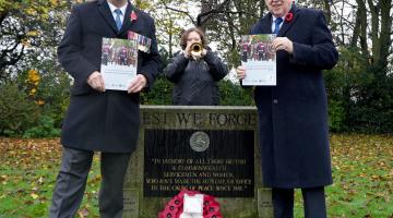 Two men holding the guide for Armed Forces personnel