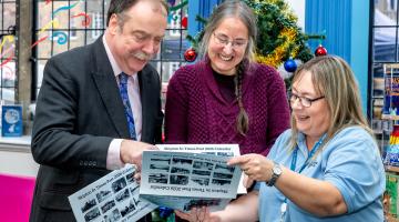 Councillor Myers looking at calendars with two colleagues