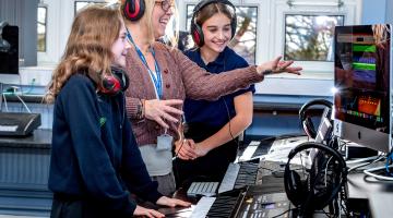 Wensleydale School’s headteacher Julia Polley is pictured with pupils Nina Wilmington, left, and Lilly Dalton using keyboards and state-of-the-art computer software to compose music.