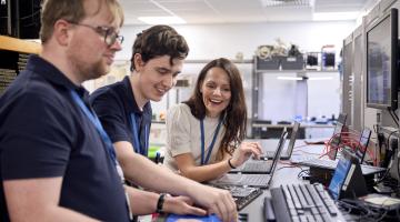 Madeline, James and Thomas using a computer