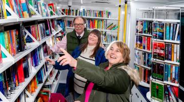 North Yorkshire Council’s executive member for libraries, Cllr Simon Myers, scanning the bookshelves with Kath Jackson and Liz Hornby, who sit on Horton in Ribblesdale Parish Council.