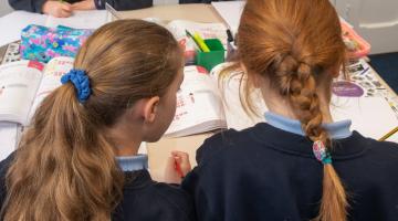 Two young girls in a classroom