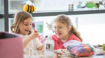 Two young girls enjoying FEAST activities