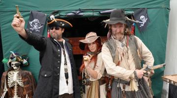 Three people dressed as pirate at Whitby Fish and Ships Festival