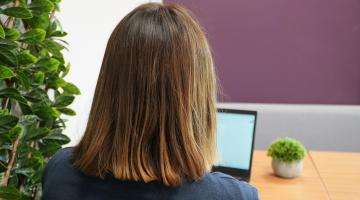 A lady looking at a laptop