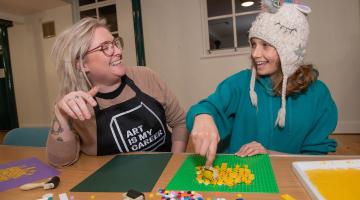 Robyn Corrigan, aged 12, creates artwork at the Lego workshop in Selby with Laura Sanderson.