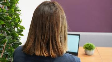 A lady looking at a laptop