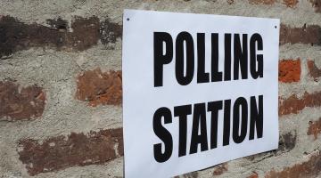 Polling Station sign on a brick wall