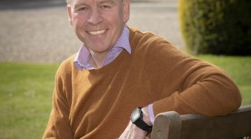 Richard Flinton pictured sitting on a bench in the grounds of County Hall in Northallerton.