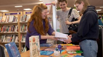 Outreach librarian Claire Thompson, left, shares North Yorkshire Libraries’ free Self-Care Toolkit with interested teenagers. 