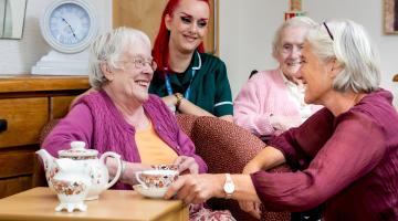 Three older adults and a care worker