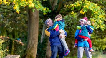 A family of four in the woods
