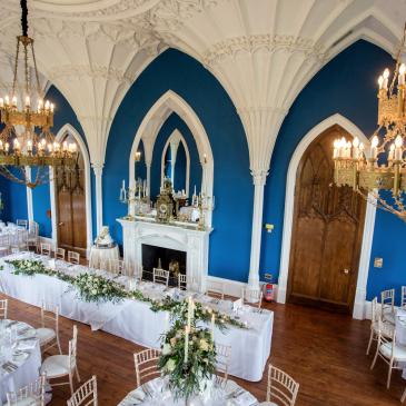 Chairs and tables laid out with floral centre pieces.