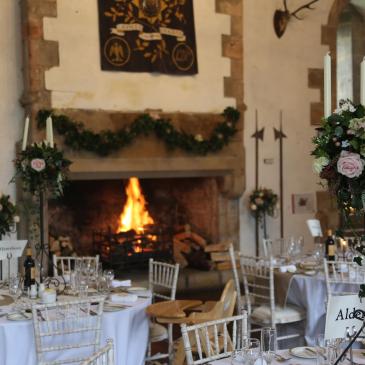 Fireplace with decorated tables and chairs.