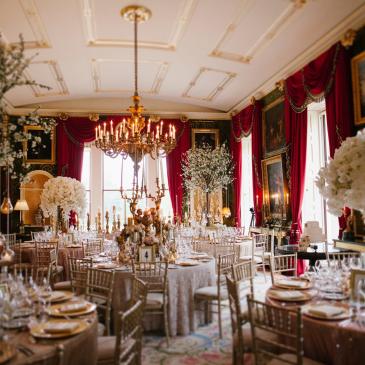 Beautifully set tables and chairs with floral centre pieces.
