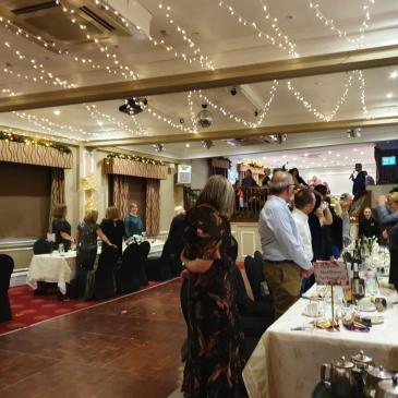 Wedding celebrations in a large hall with fairy lights.