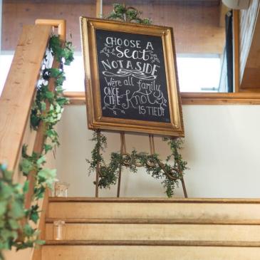 Chalkboard with information for wedding guests.