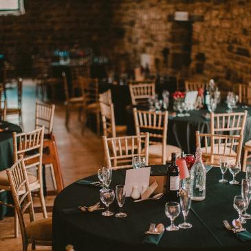 Tables and chairs with wine glasses ready for dinner.