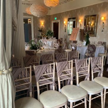 Chairs and tables set out for a wedding dinner.