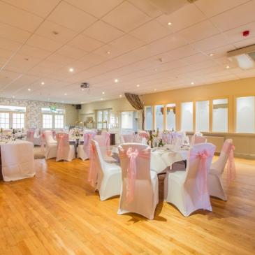 Hall with tables set for wedding 